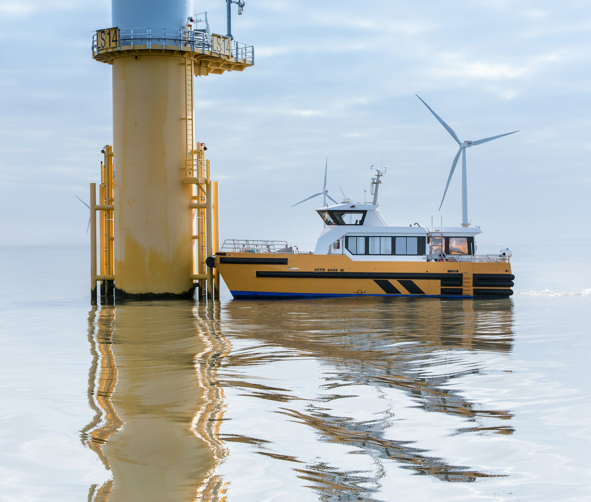 Service boat and wind turbine at offshore windfarm